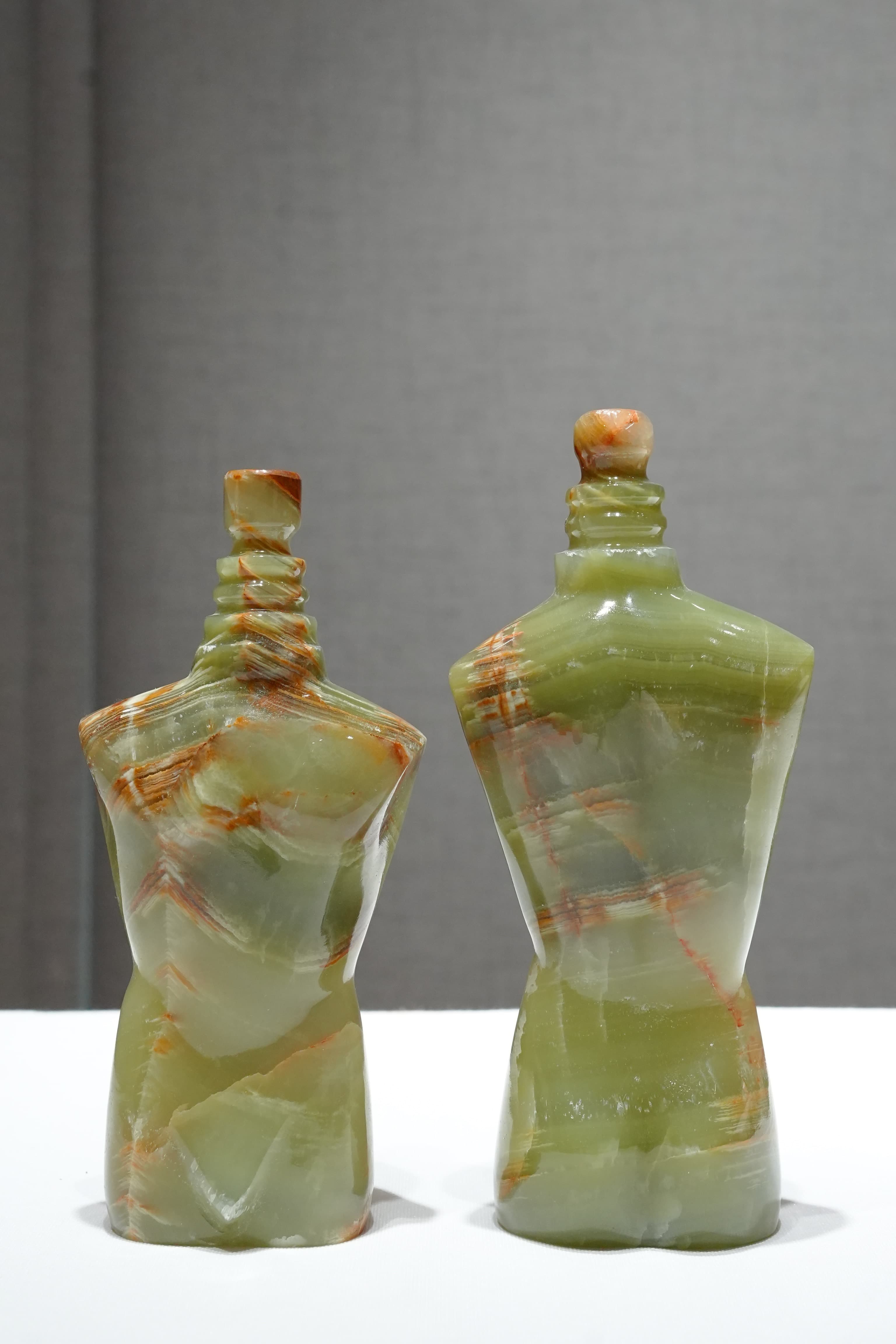 Pair of green onyx decorative bottle forms with fitted stoppers
