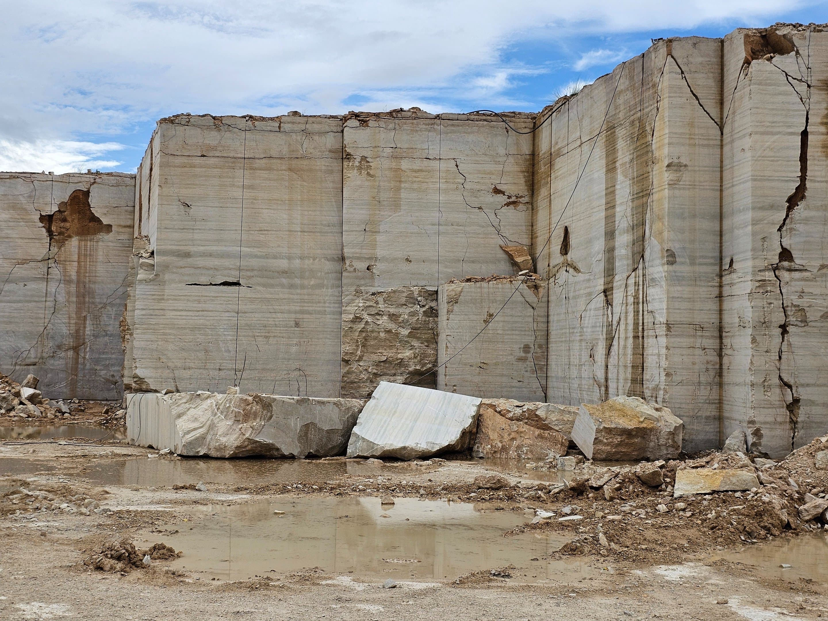 Raw travertine quarry wall in Loralai, Balochistan, showing natural banded stone strata